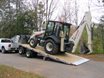 Sliding axle trailer with excavator